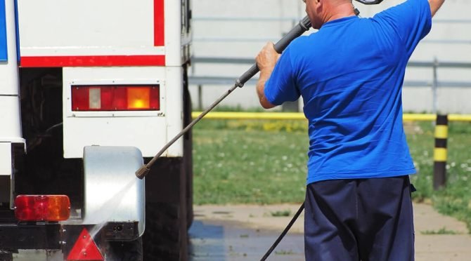 car-wash-heavy-vehicles-trucks-male-car-wash-worker-washes-truck-with-water-gun-street-summer-day (1)